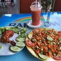 Arabic salad, fried chicken with fresh strawberry, orange and apple juice