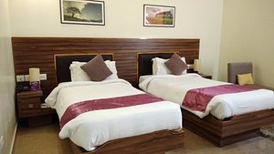 Hotel Poinisuk in Shillong, image may contain: Bed, Hotel, Cushion, Interior Design