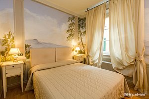 Albergo San Martino in Lucca, image may contain: Bed, Furniture, Home Decor, Bedroom