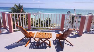Caye Caulker Condos in Caye Caulker, image may contain: Balcony, Building, Chair, Furniture