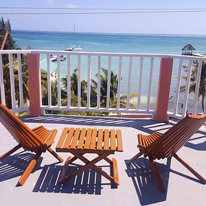 Caye Caulker Condos in Caye Caulker, image may contain: Balcony, Building, Chair, Furniture