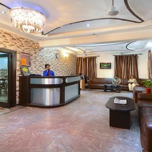 Hotel Prashant Palace in Agra, image may contain: Reception, Table, Floor, Flooring