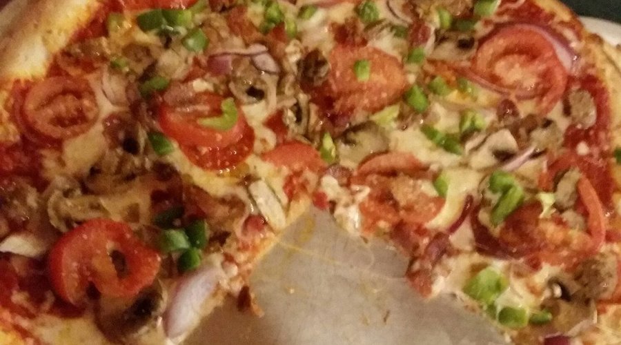 the Chieftain Signature pizza; Pepperoni Saus. Bacon Mushrooms Onion Tomato Gr Pepper Rom Cheese