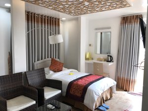 Crystal Palace Hotel in Yangon (Rangoon), image may contain: Remote Control, Interior Design, Chair, Bed