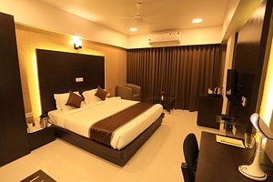 Hotel Ramashray Paradise in Dewas, image may contain: Interior Design, Corner, Chair, Resort