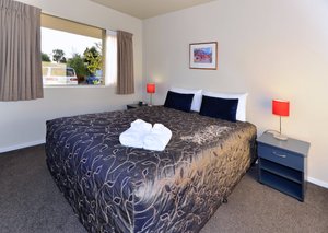 Arena Motel in Christchurch, image may contain: Lamp, Bed, Furniture, Dorm Room