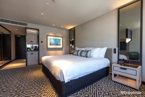 The Star Grand Hotel And Residences in Sydney, image may contain: Furniture, Bed, Bedroom, Lamp