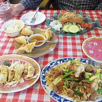 Clockwise from bottom right, pork w/noodles, pork dumplings, crab rangoon, and salmon w/vegetabl