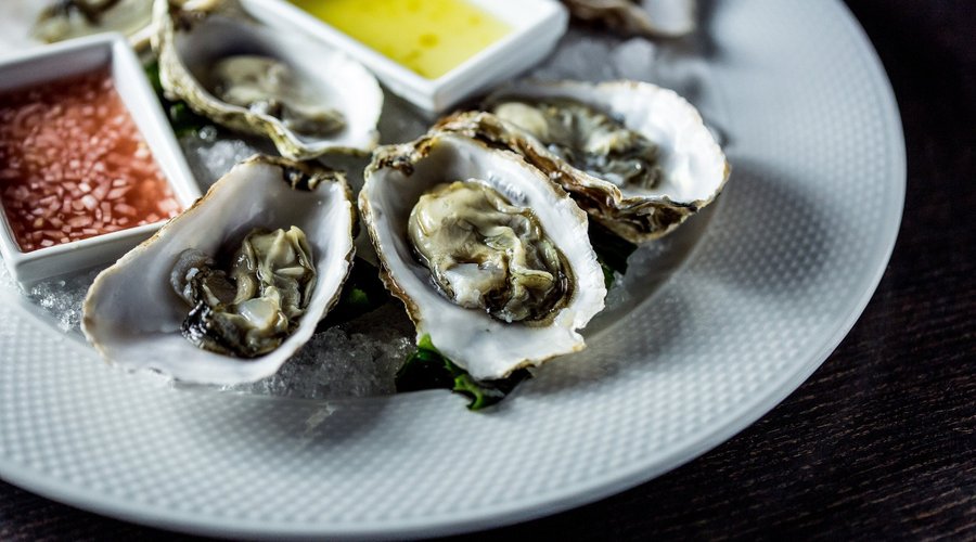 Fresh oyster on bed of ice with balsamic vinegar