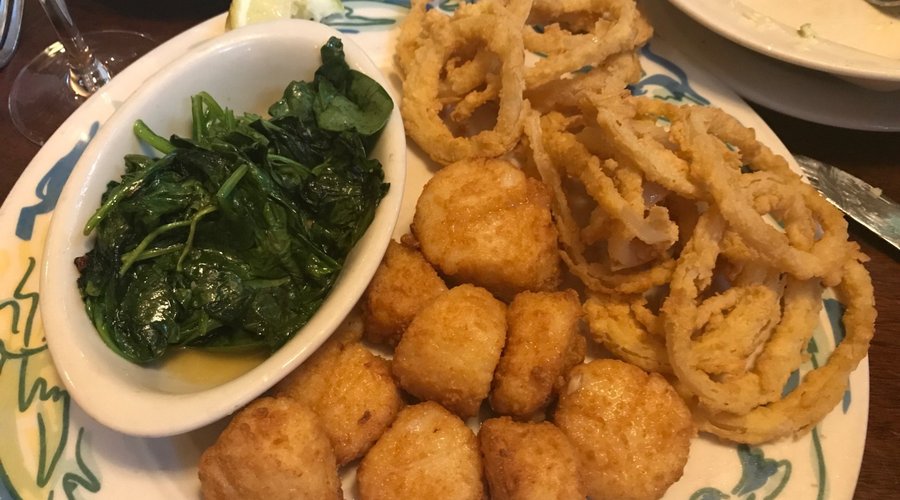 fried sea scallops, onion rings and spinach.