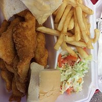 Fried fish platter with fries and salad.