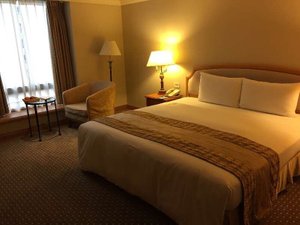 Han-Hsien International Hotel in Lingya, image may contain: Bed, Furniture, Lamp, Chair