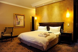 Anta Boga Hotel in Bloemfontein, image may contain: Furniture, Handbag, Bed, Bedroom