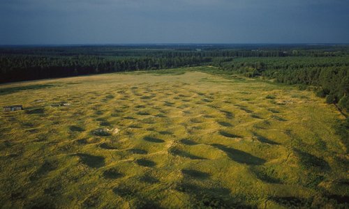 An aerial view showing the lunar-like lanscape of filled-in flint mine-shafts  