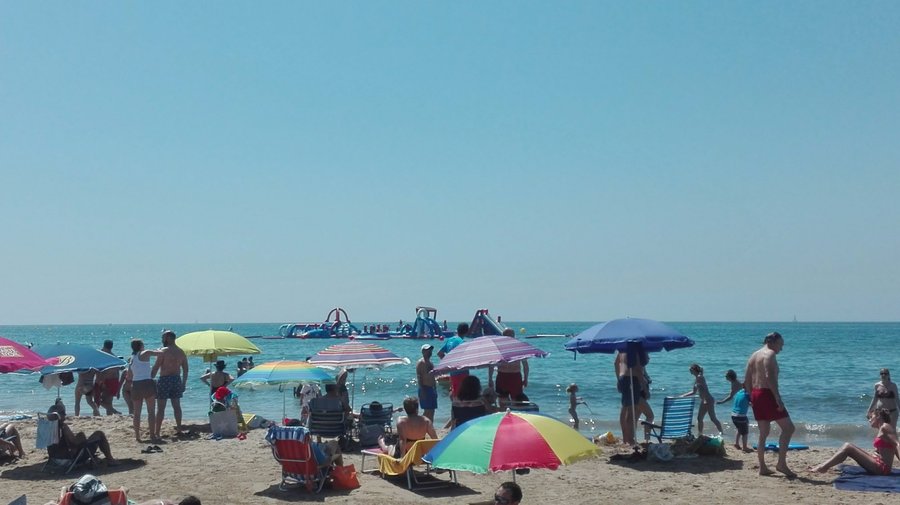 vista de la playa y atraccion de agua inchable