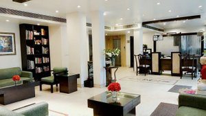 Rockland Hotel C R Park in New Delhi, image may contain: Living Room, Home Decor, Chair, Table