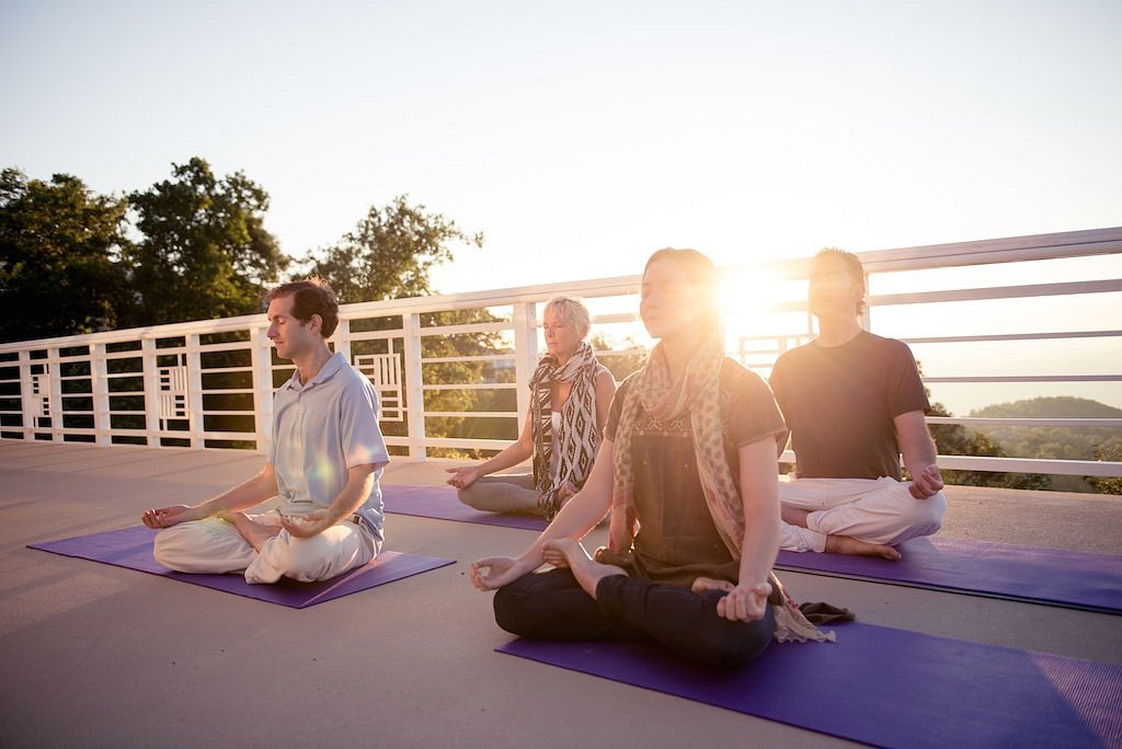 mother and daughter doing yoga and meditation indoor in a glamping