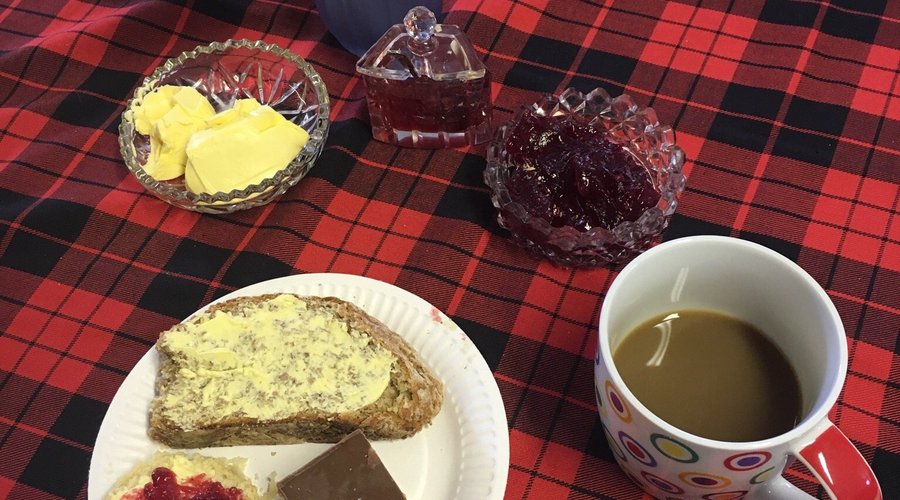 Coffee with scones, wheaten bread and a chocolate traybake.