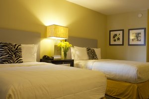 Sole Inn and Suites in Pensacola, image may contain: Furniture, Bedroom, Bed, Indoors