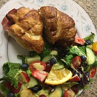 Hot ham and brie croissant with a side salad