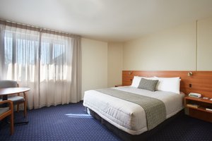 Ventura Inn & Suites Hamilton in Hamilton, image may contain: Furniture, Dorm Room, Bedroom, Home Decor