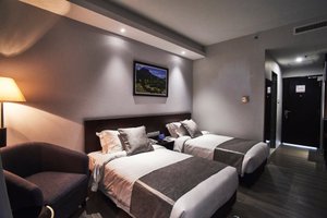 Meritin Hotel in Kuching, image may contain: Bed, Furniture, Chair, Painting