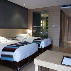 Huashan International Hotel in Xi'an, image may contain: Interior Design, Bed, Furniture, Bedroom