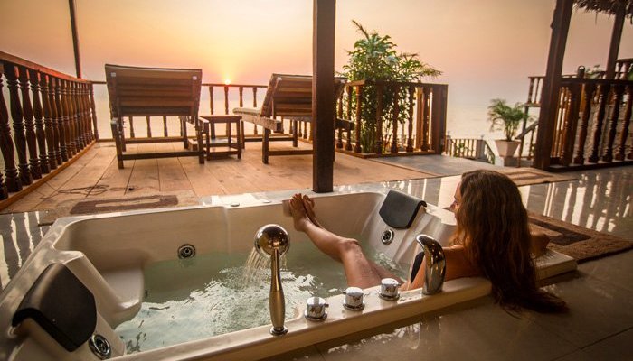 Your own Jacuzzi on your terrace looking out over the ocean at sunset.