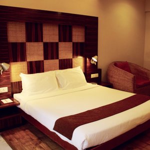 Hotel Jewel Of Chembur in Mumbai, image may contain: Bed, Furniture, Chair, Bedroom