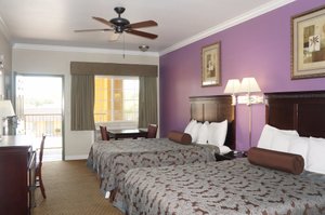 Americas Best Value Inn & Suites Clovis Fresno in Clovis, image may contain: Painting, Chair, Bed, Lamp