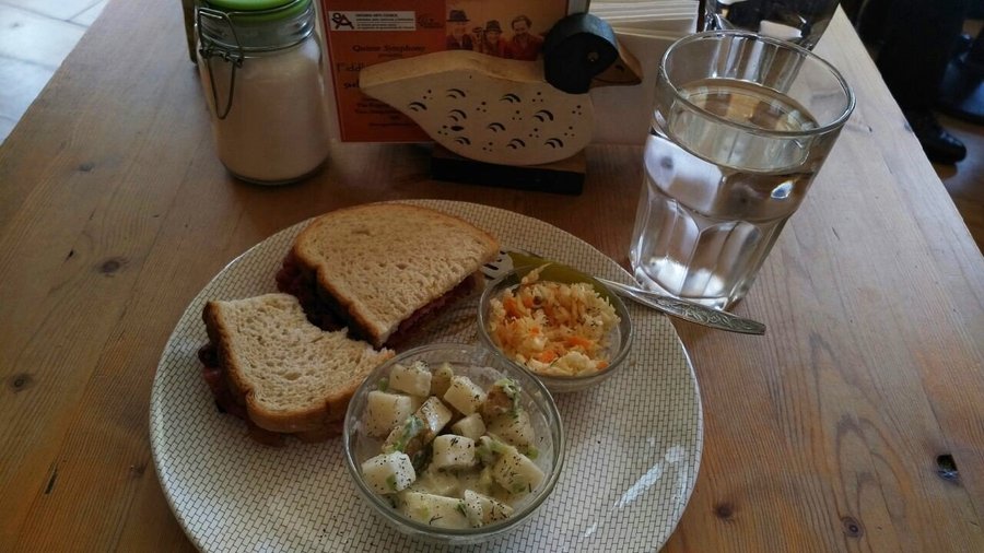Montreal smoked meat (with a bite missing), and homemade sides