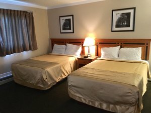 Sunrise Motel in Regina, image may contain: Bed, Furniture, Bedroom, Indoors