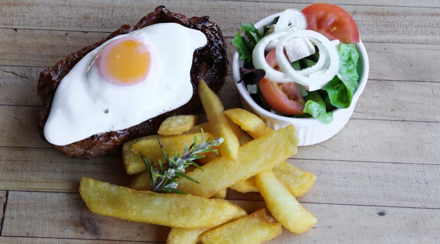 Steak, egg, garlic butter, chips & salad