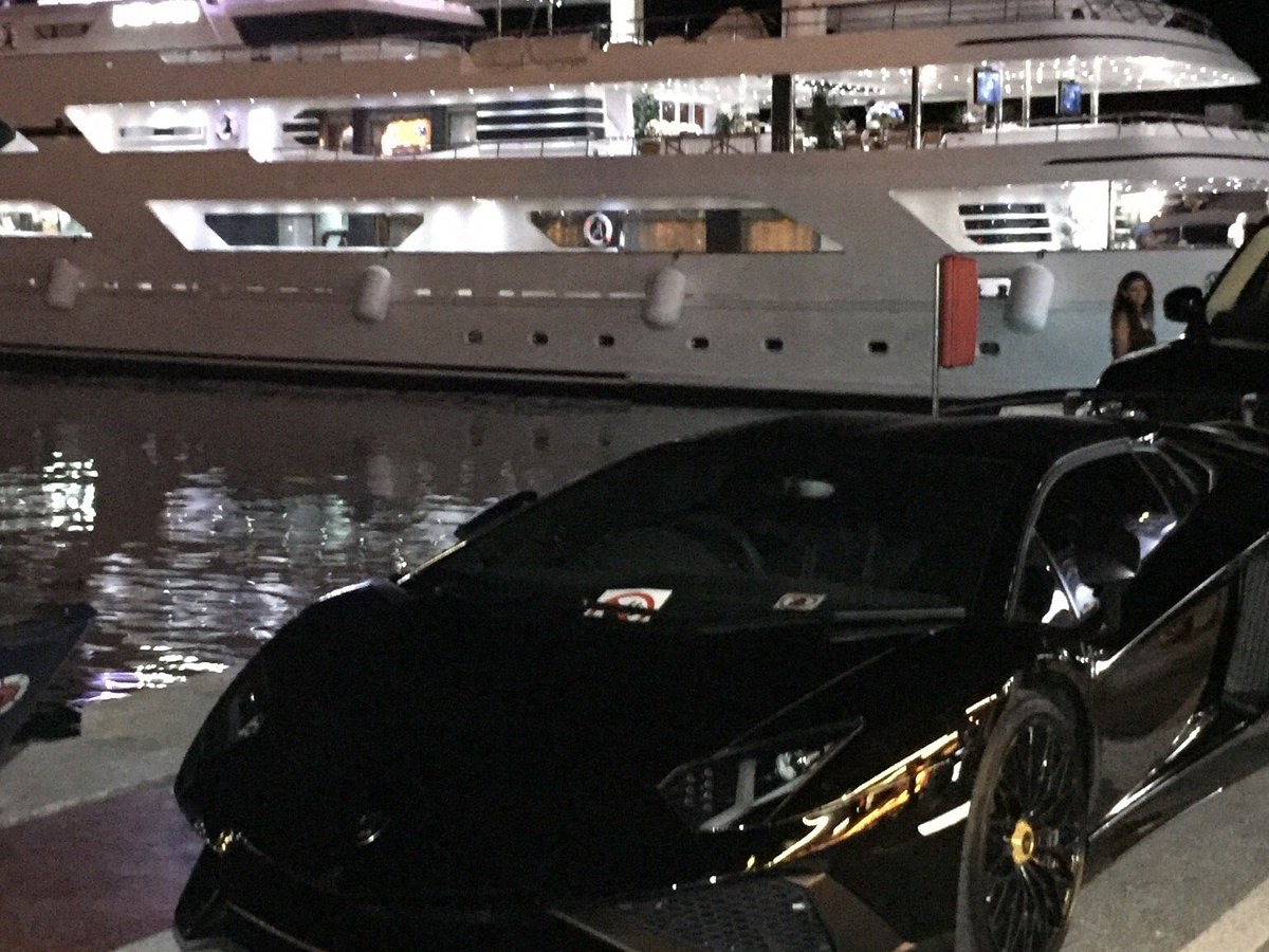 Puerto Banús, with luxury cars parked in port, Yachts behind