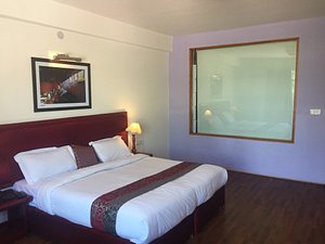 Hotel Himalaya Villa in Leh, image may contain: Bed, Furniture, Corner, Bedroom