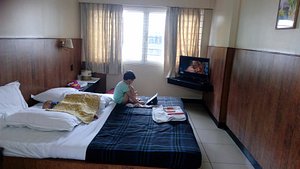 Hotel Vaidurya in Coimbatore, image may contain: Monitor, Screen, Person, Dorm Room