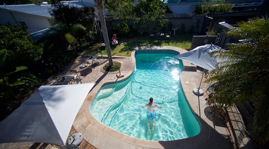 Leisure area with relaxing grass bank and pool with seating area