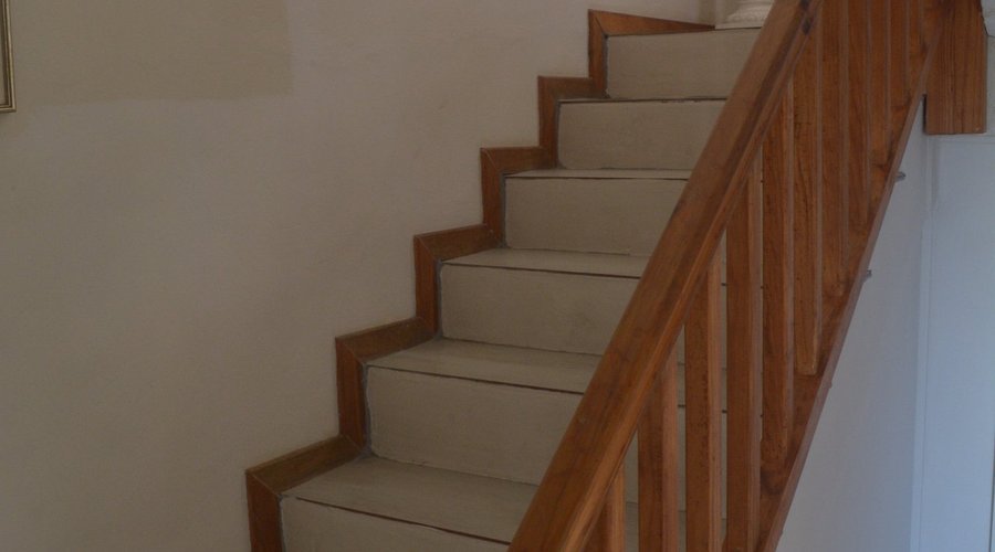 Staircase to first floor rooms/unit & dining/living area.