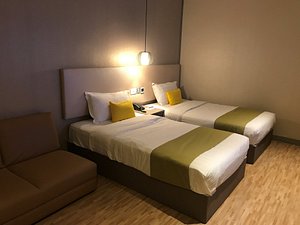 Champion Hotel in Singapore, image may contain: Bed, Furniture, Couch, Bedroom