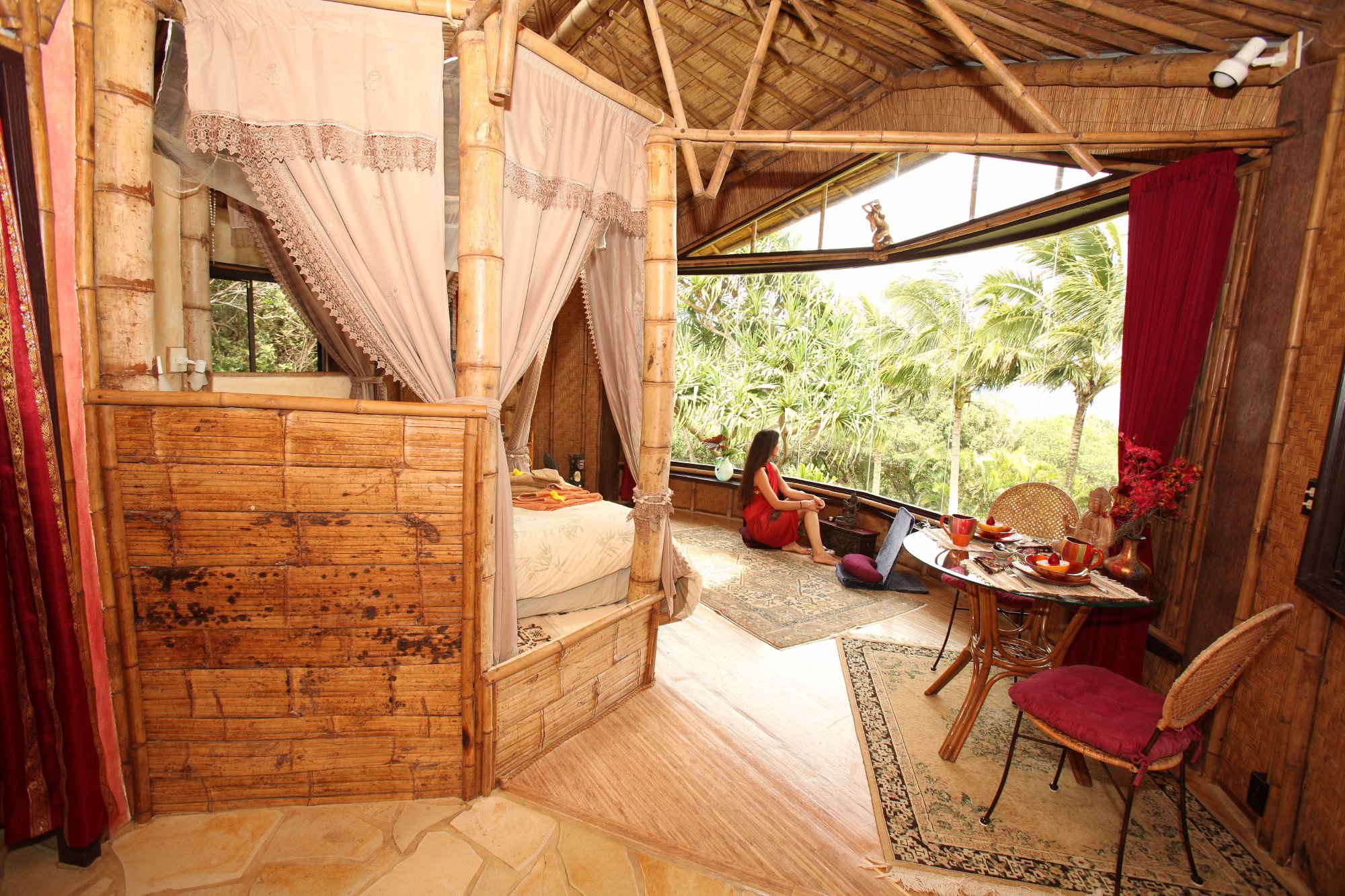 Woman looking out over greenery from one of the most dreamy Airbnbs in Maui