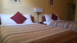Robber's Roost Motel in New Hazelton, image may contain: Cushion, Home Decor, Furniture, Bed