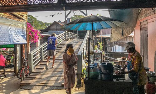 The wooden bridge over the klong 12 and local food vendor