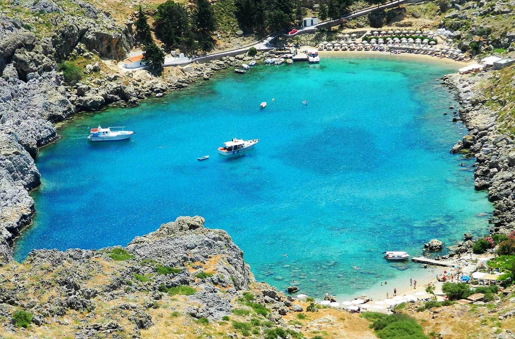 Boats and ferry on the water in a beautiful blue bay