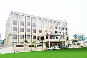 Broadway Inn in Meerut, image may contain: Office Building, Grass, Lawn, Car