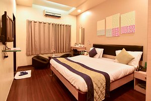 Hotel Sapna in Pune, image may contain: Dorm Room, Bed, Furniture, Bedroom