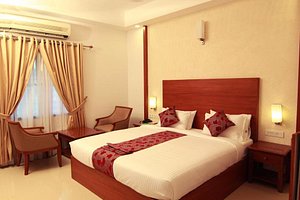 Royale Park in Alappuzha, image may contain: Hotel, Resort, Bed, Lamp