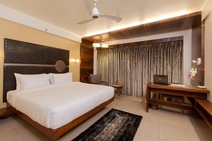 Hotel Cosmopolitan in Ahmedabad, image may contain: Interior Design, Corner, Ceiling Fan, Laptop