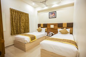 Grande Inn in Tiruchirappalli, image may contain: Interior Design, Bed, Furniture, Painting