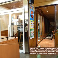 Inside view of entrance to MosBurger Shimodate,Chikusei. Mirror shows customer at counter.