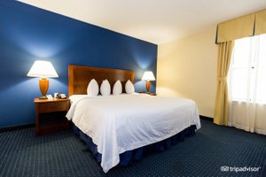 Doral Inn & Suites, Miami Airport West in Doral, image may contain: Furniture, Bedroom, Bed, Indoors